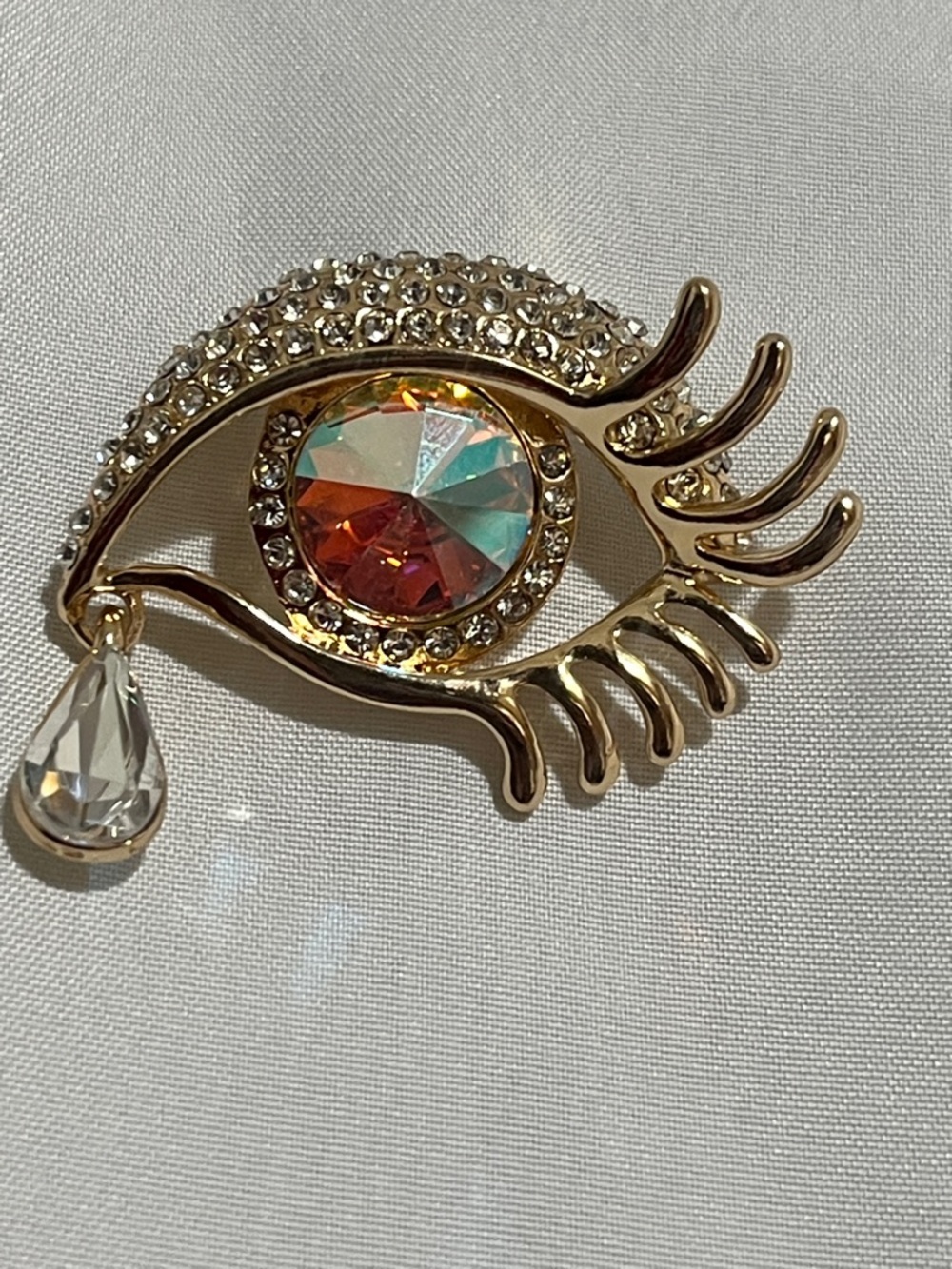 Faux Crystal Eye Brooch In Gold